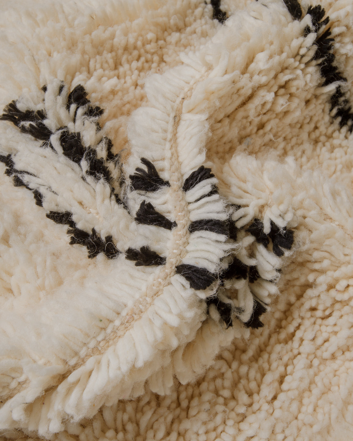 Close up of cream Azilal rug with black details.