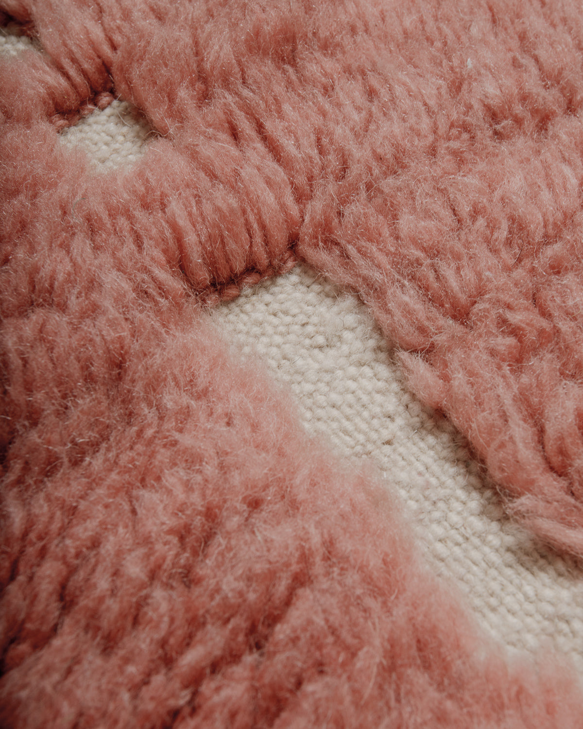 Close-up of a textured rose wool surface