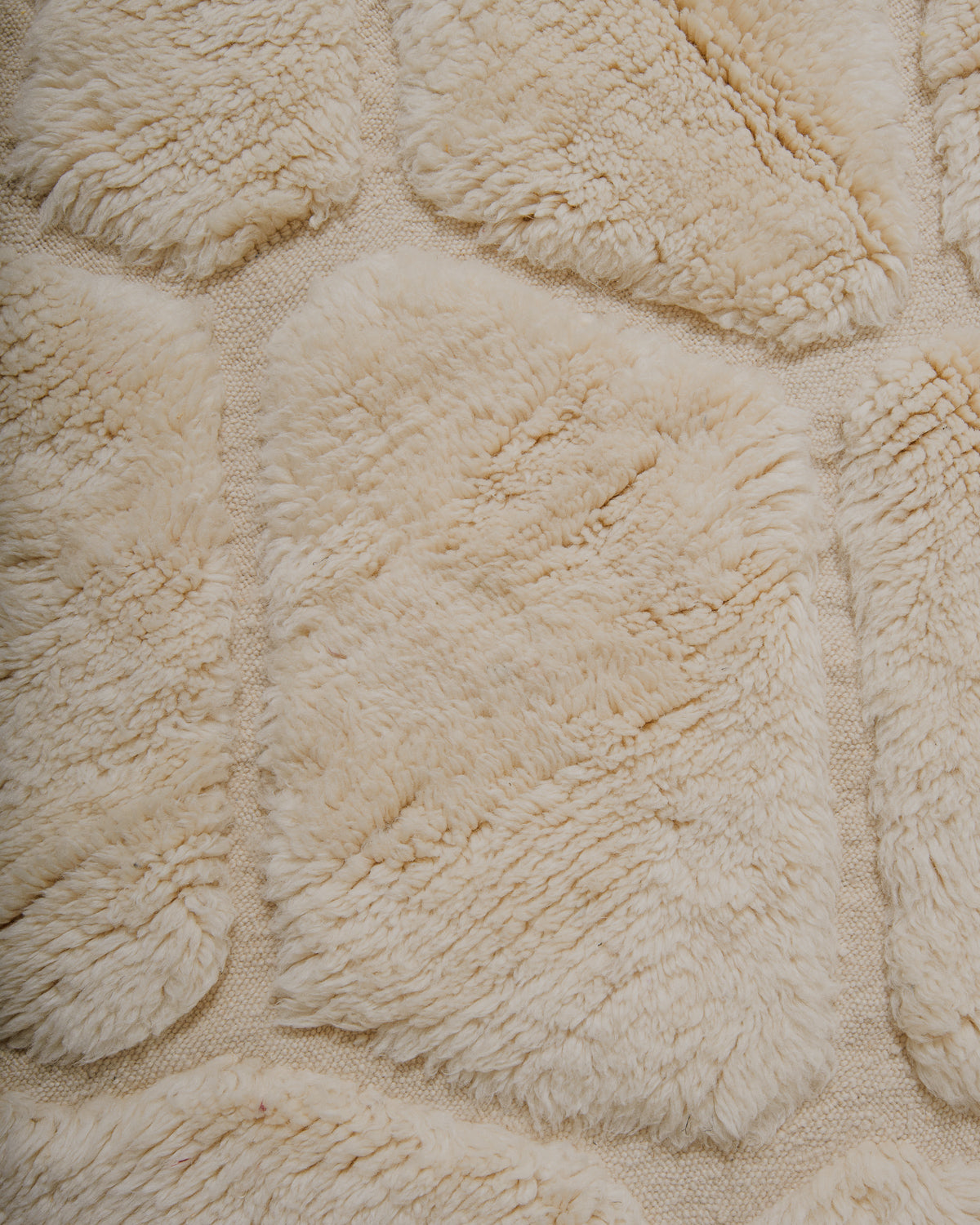 Close up of surface of cream wool rug.
