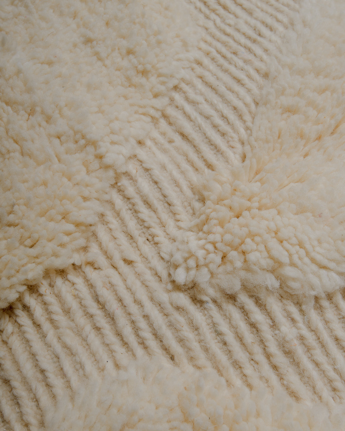 Close up of cream wool rug.