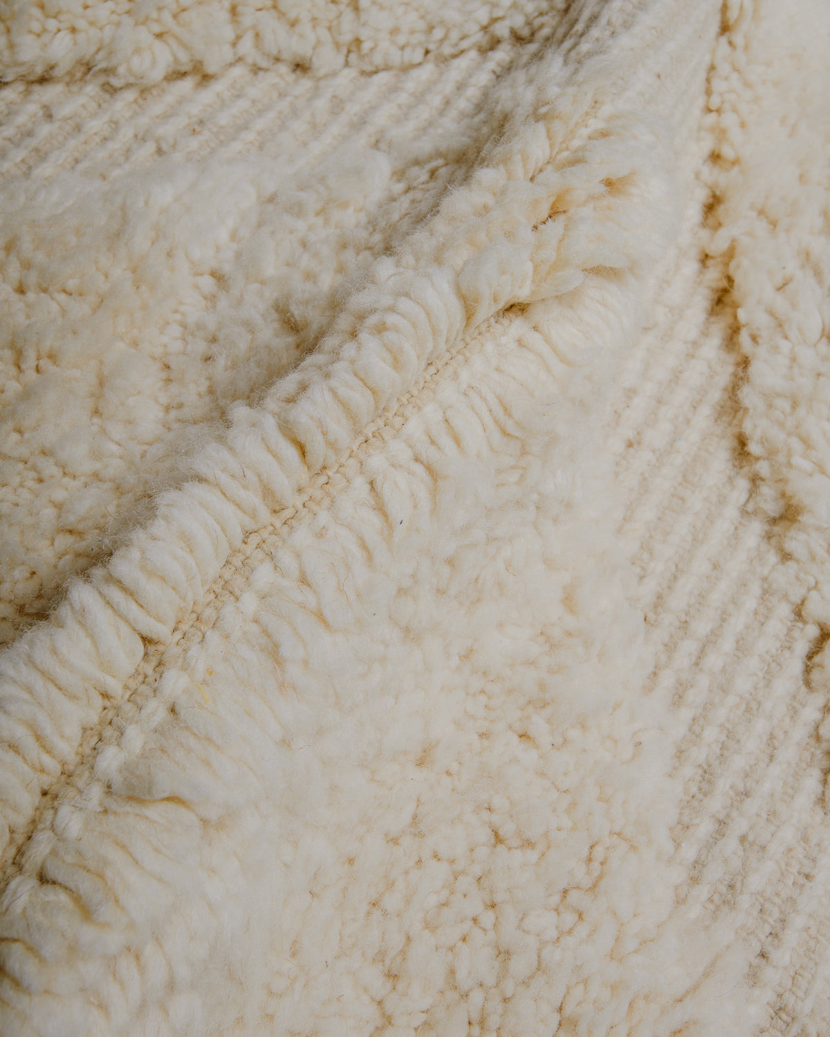 Close up of cream wool rug.