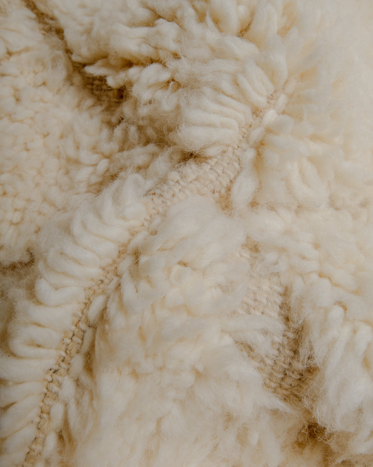 Close up of cream wool rug.