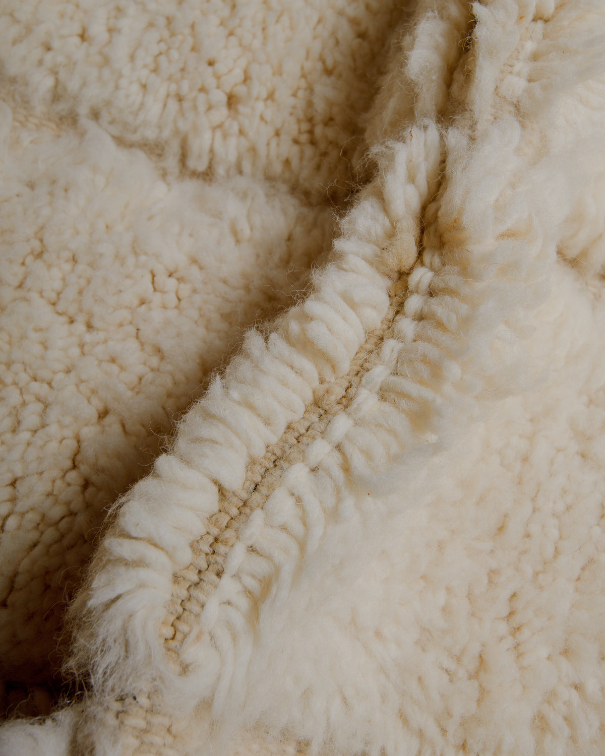 Close up of cream wool rug.
