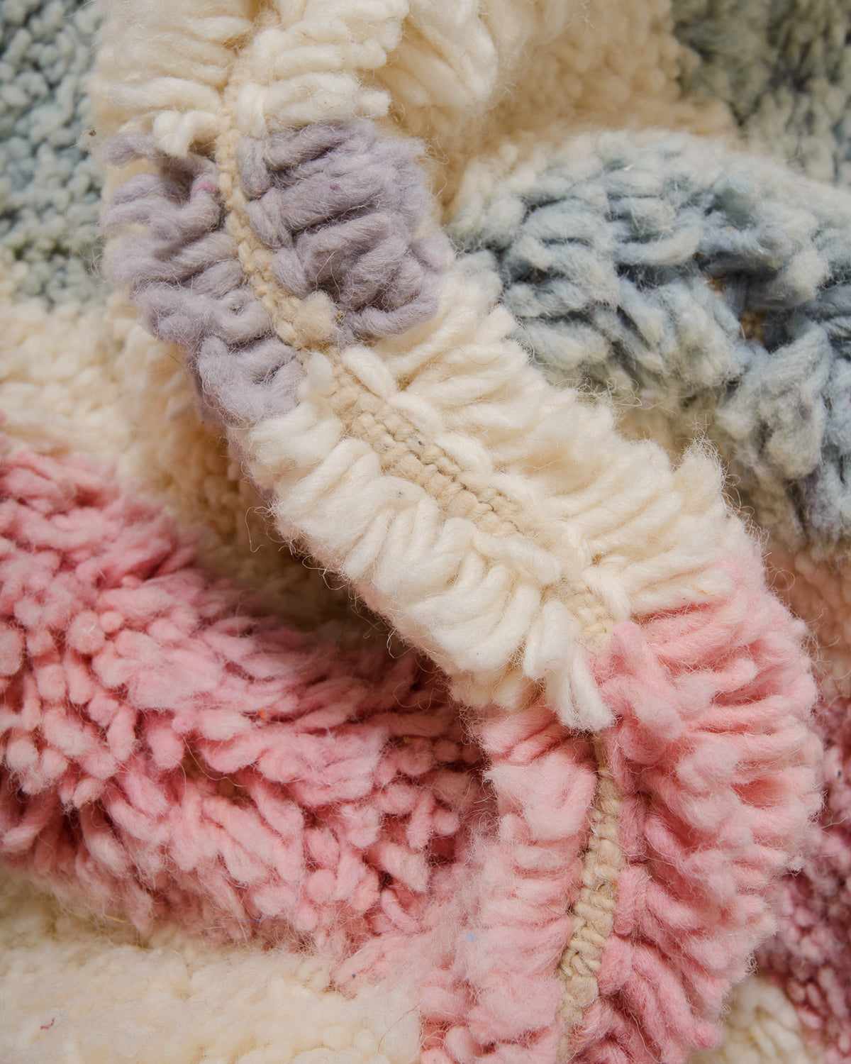 Detail of wool berber rug showing depth of pile and different coloured wool used. 