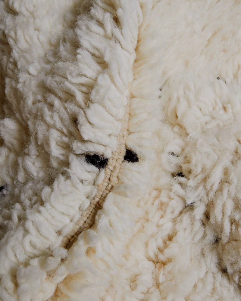 Close up of cream wool rug.