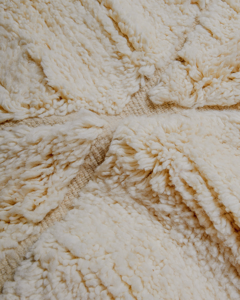 Surface of cream wool rug.