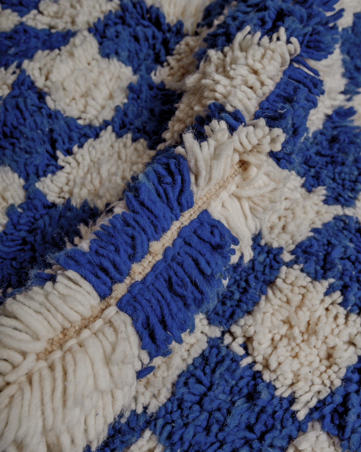 Close up showing wool in blue and white, with a soft, fluffy texture.
