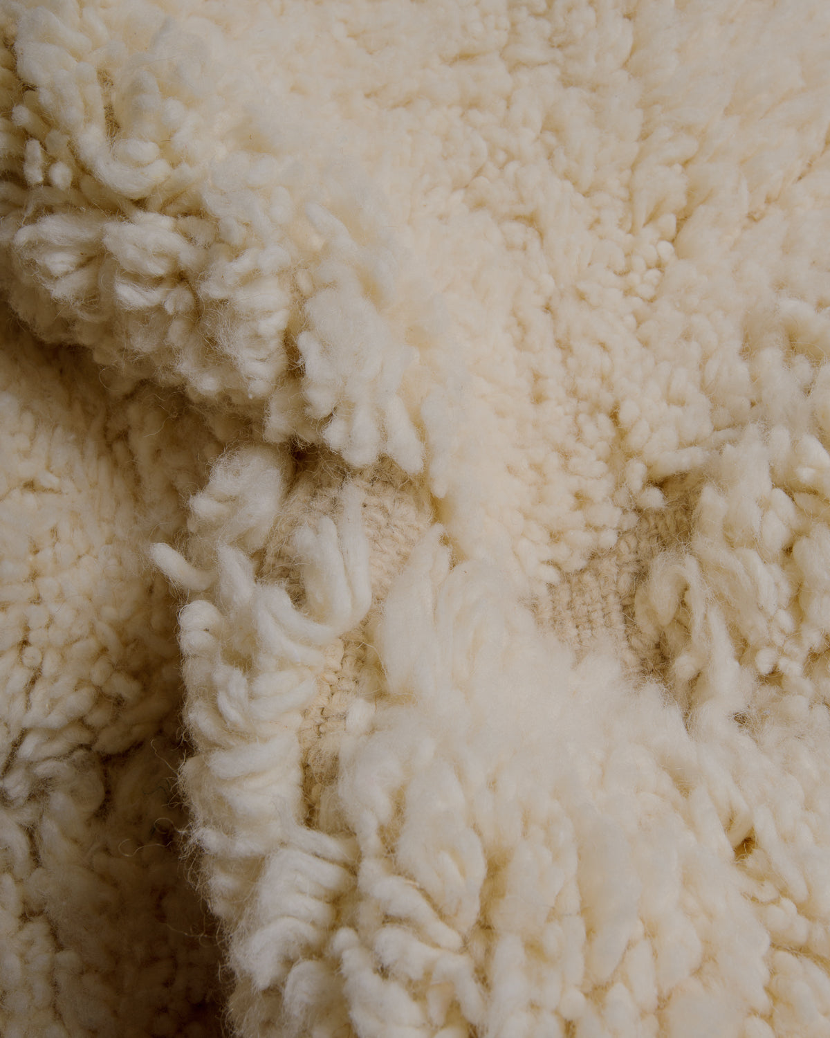 Close up of cream wool rug.