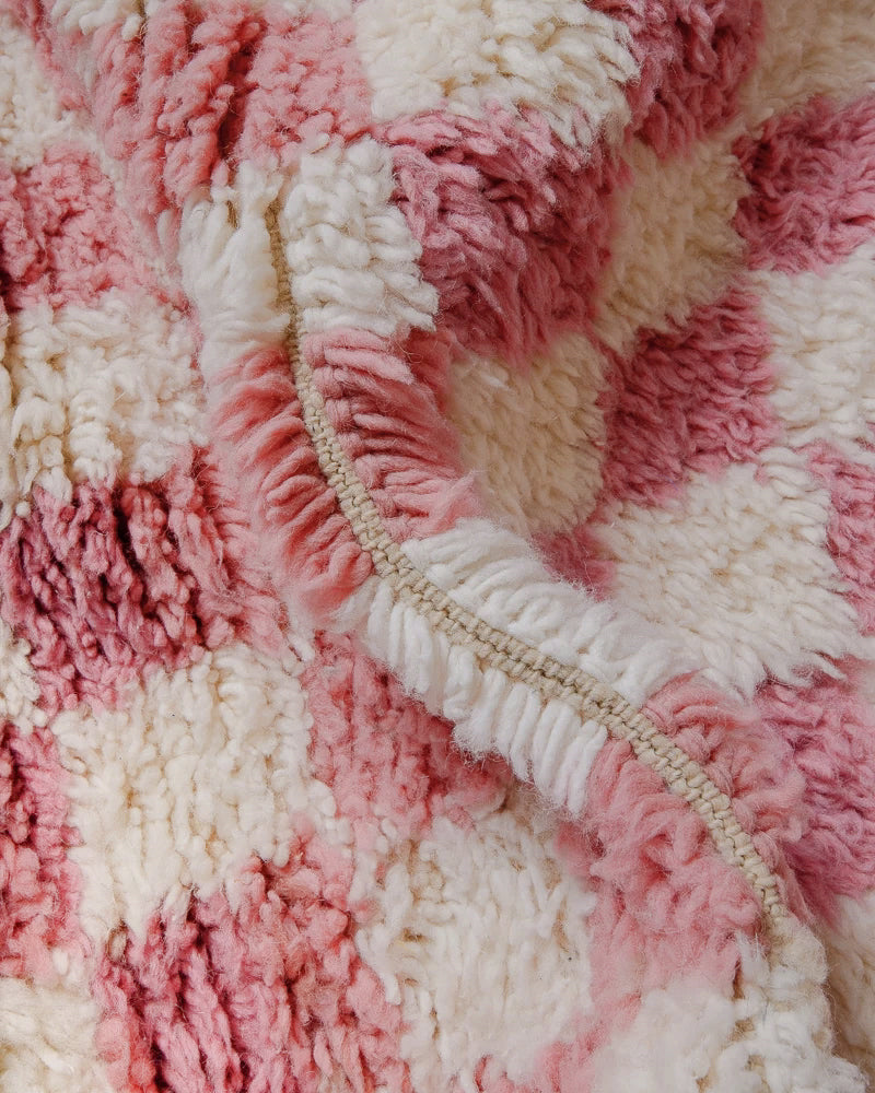 Close up of Pink checkered rug made of fluffy wool