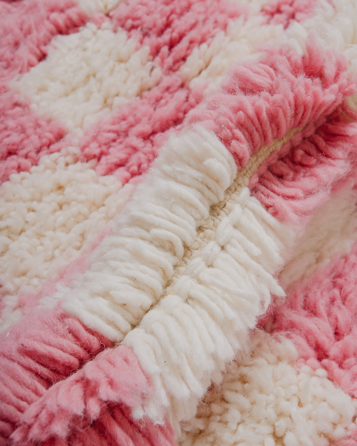 Close-up of a pink and white textured rug