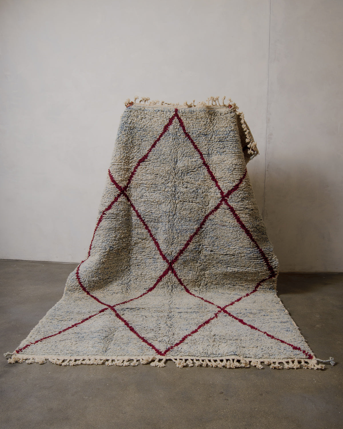 Textured rug with geometric pattern on a plain floor