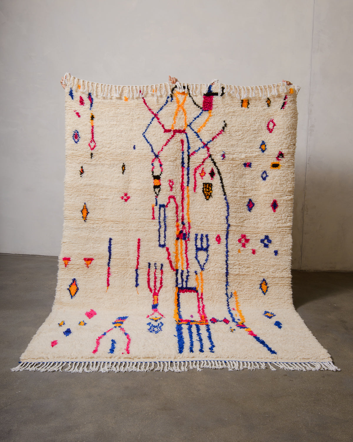 Decorative Azilal rug with colorful abstract design on a plain background