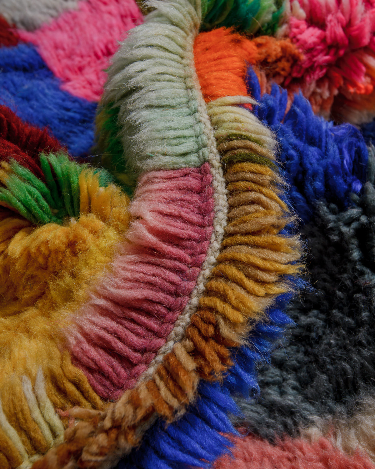 Close up of colourful wool rug showing density of the pile. 