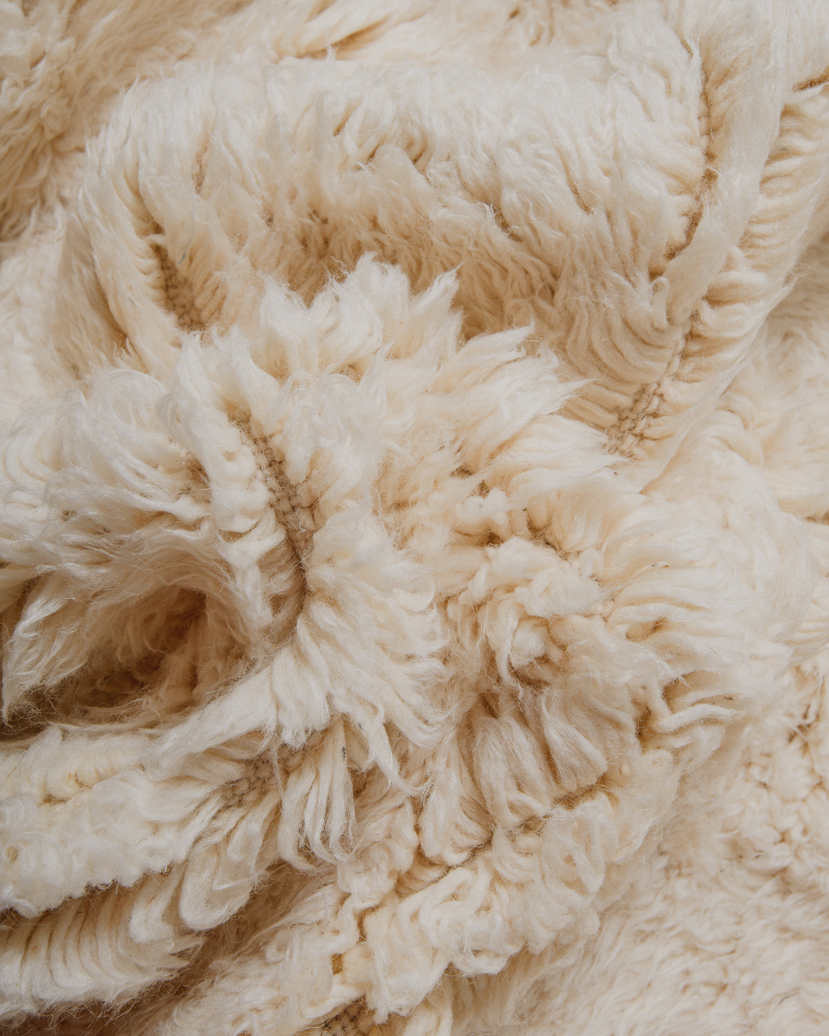 Close-up of a beige textured wool rug.