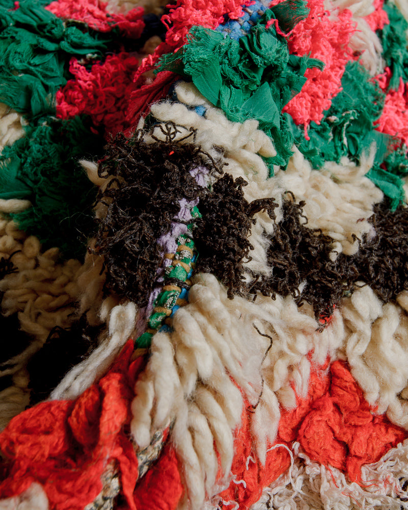 Close up of boucherouite rug with colourful cotton and fabric remnants.
