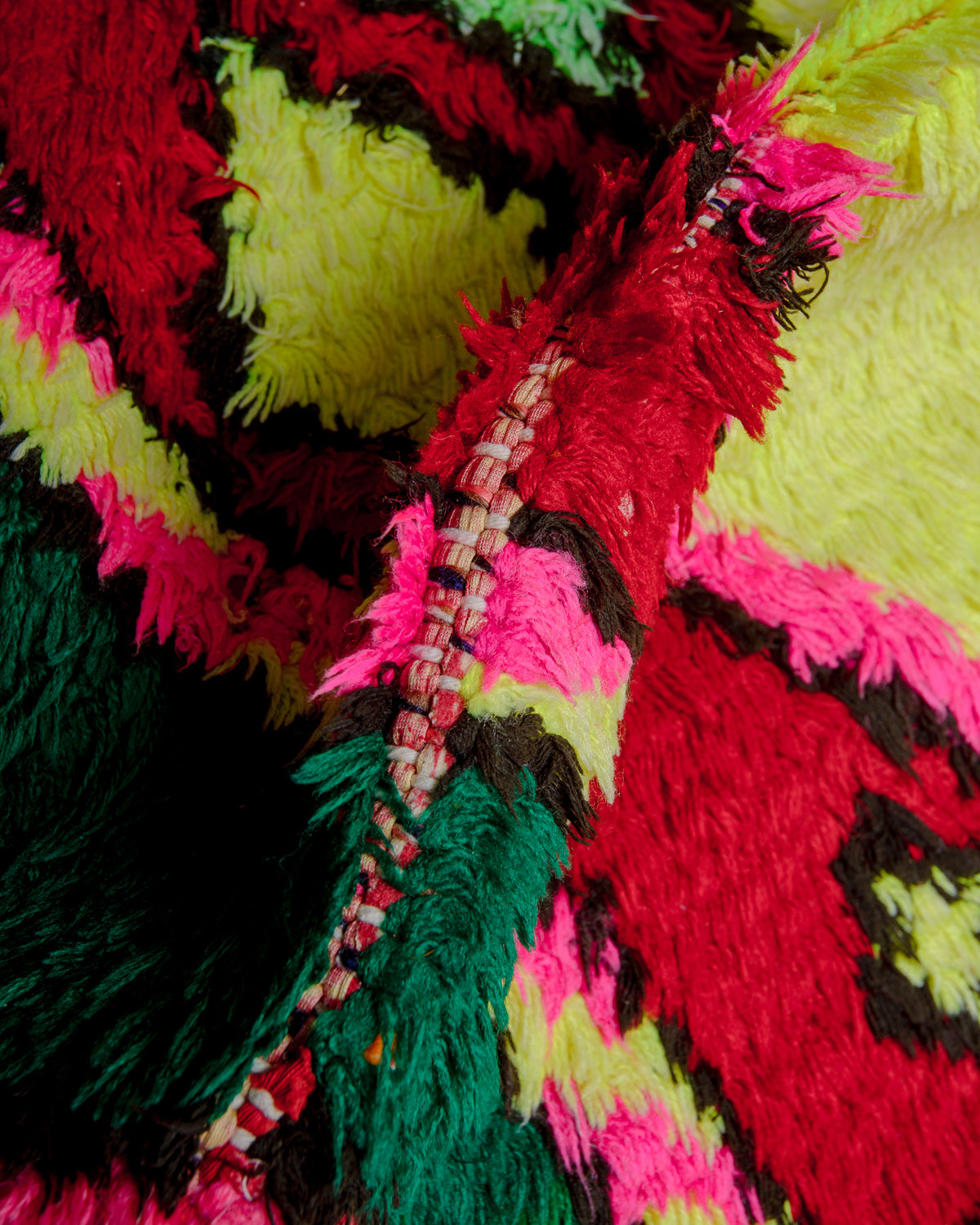 Close up of boucherouite rug with colourful cotton and fabric remnants.