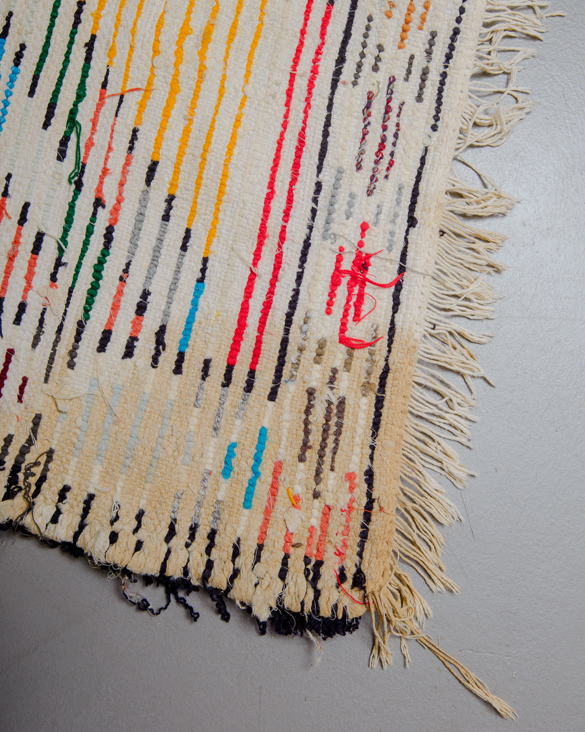 Back corner of boucherouite rug with stained area.