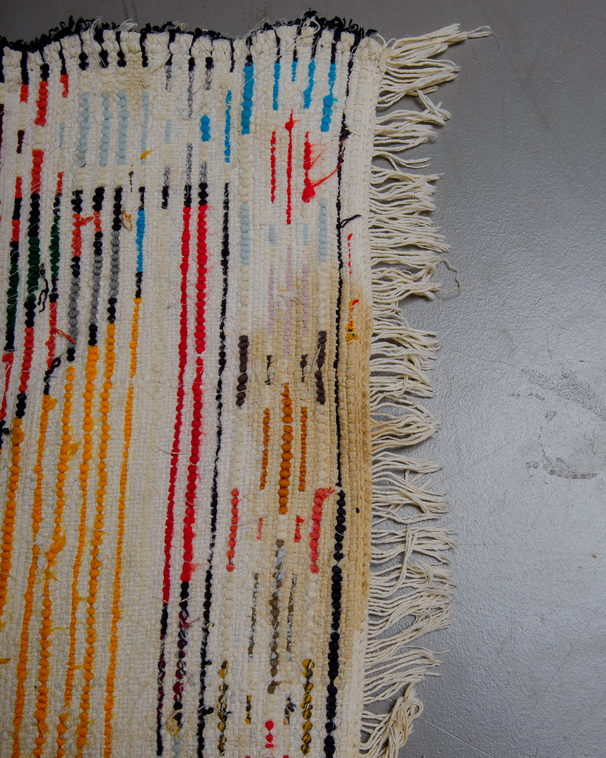 Back corner of boucherouite rug with stained area.