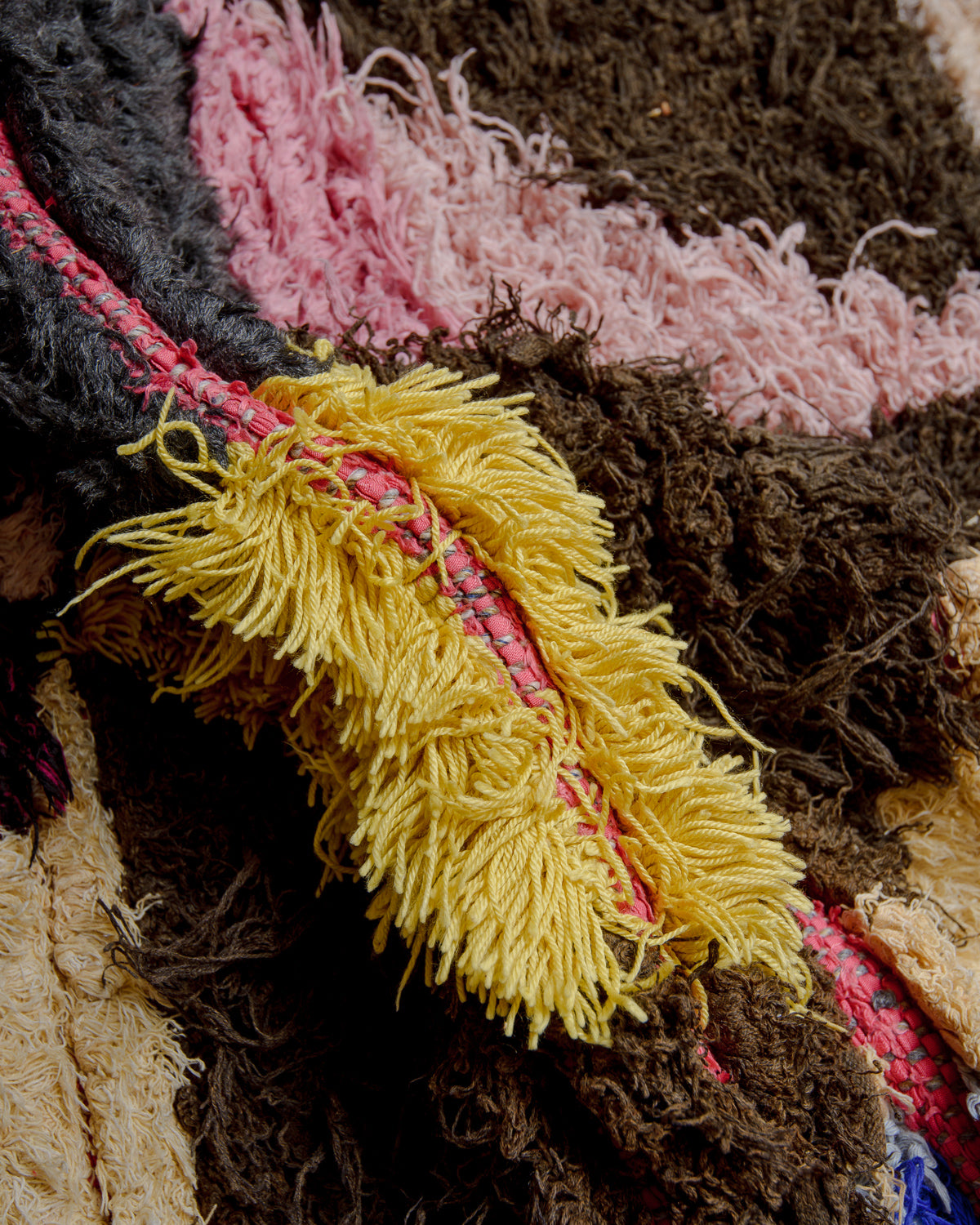 Close up of boucherouite rug with colourful cotton and fabric remnants.