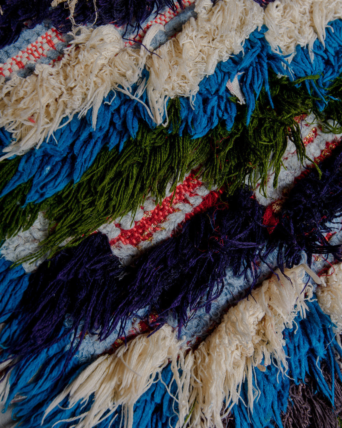 Close up of boucherouite rug with colourful cotton and fabric remnants.