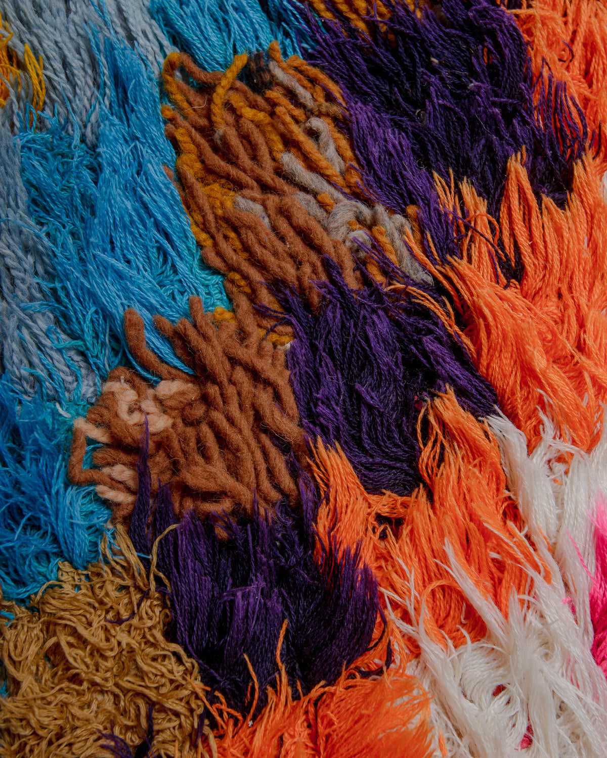Close up of boucherouite rug with colourful cotton and fabric remnants.