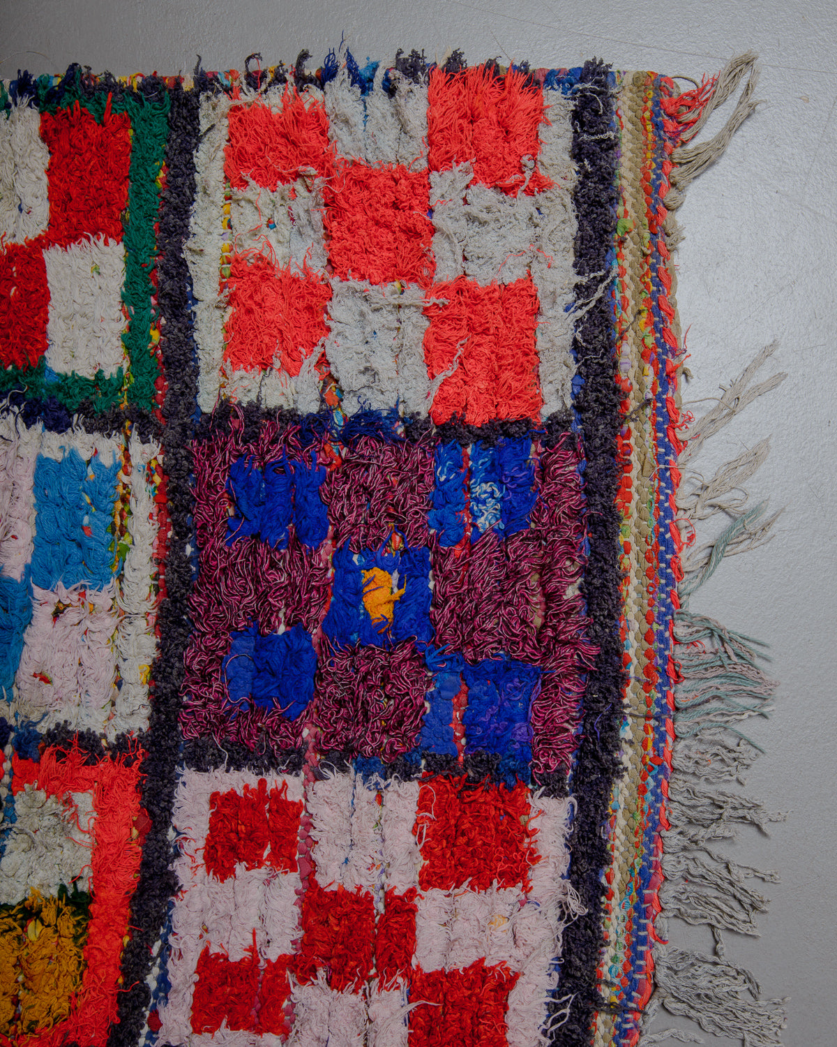 Corner of Boucherouite rug with cotton fringe.