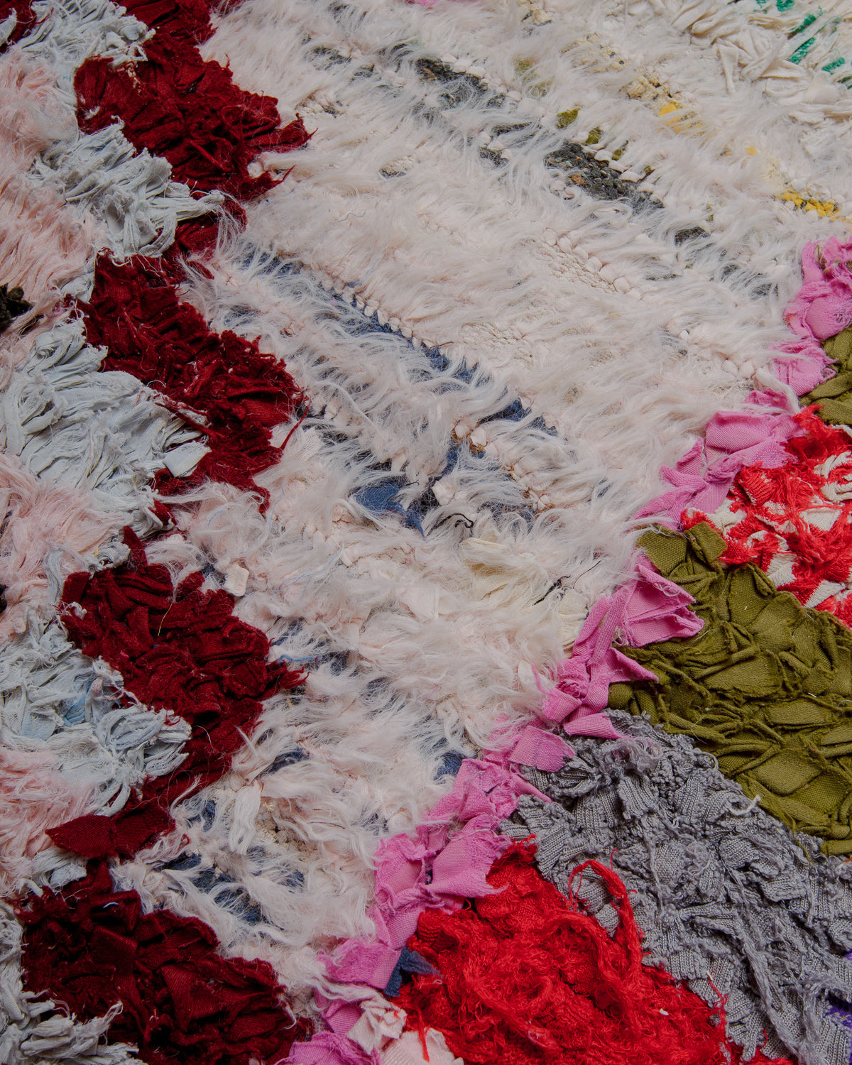 Close up of boucherouite rug with colourful cotton and fabric remnants.