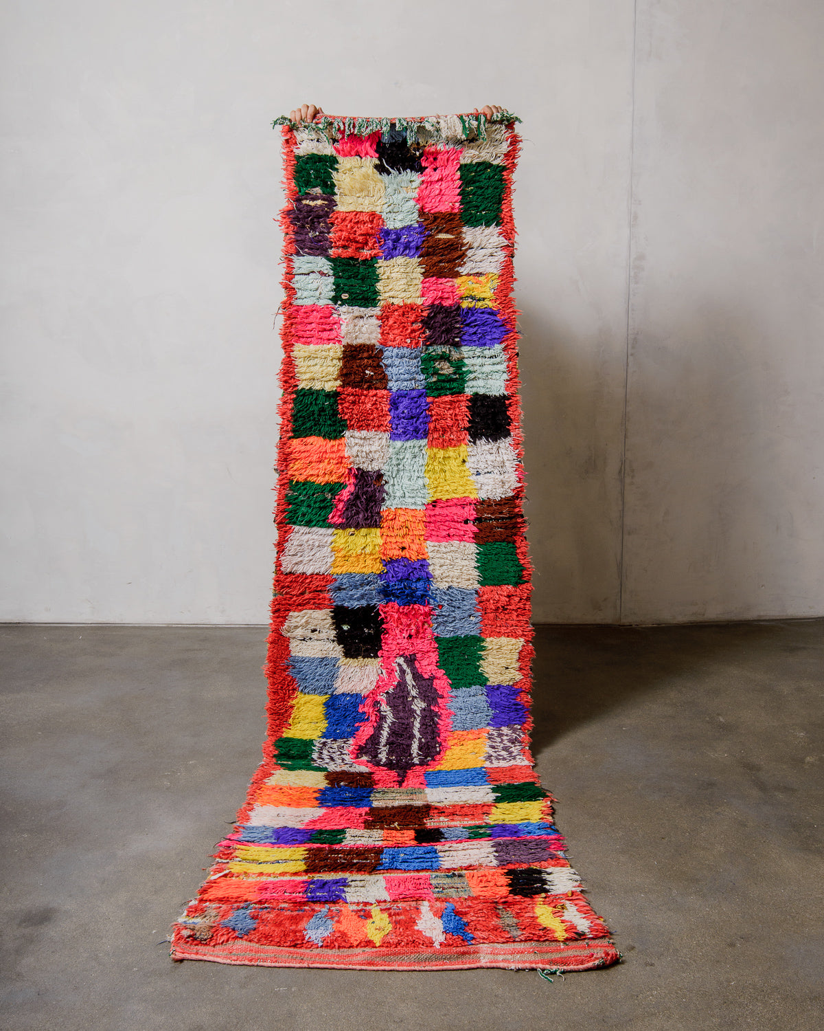 Multicolored checkered rug on a plain background