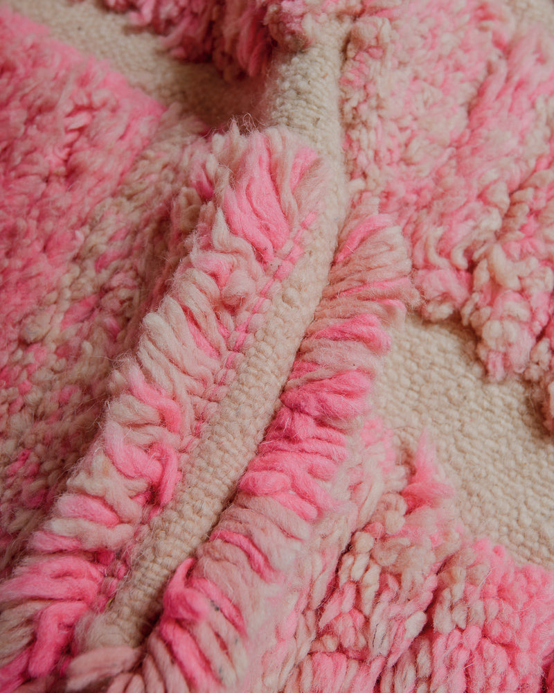 Close up of vintage wool rug showing density of wool pile and woven areas. 
