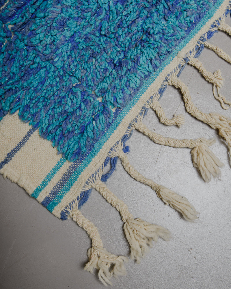 Corner of Boujaad runner rug with natural wool tassels. 