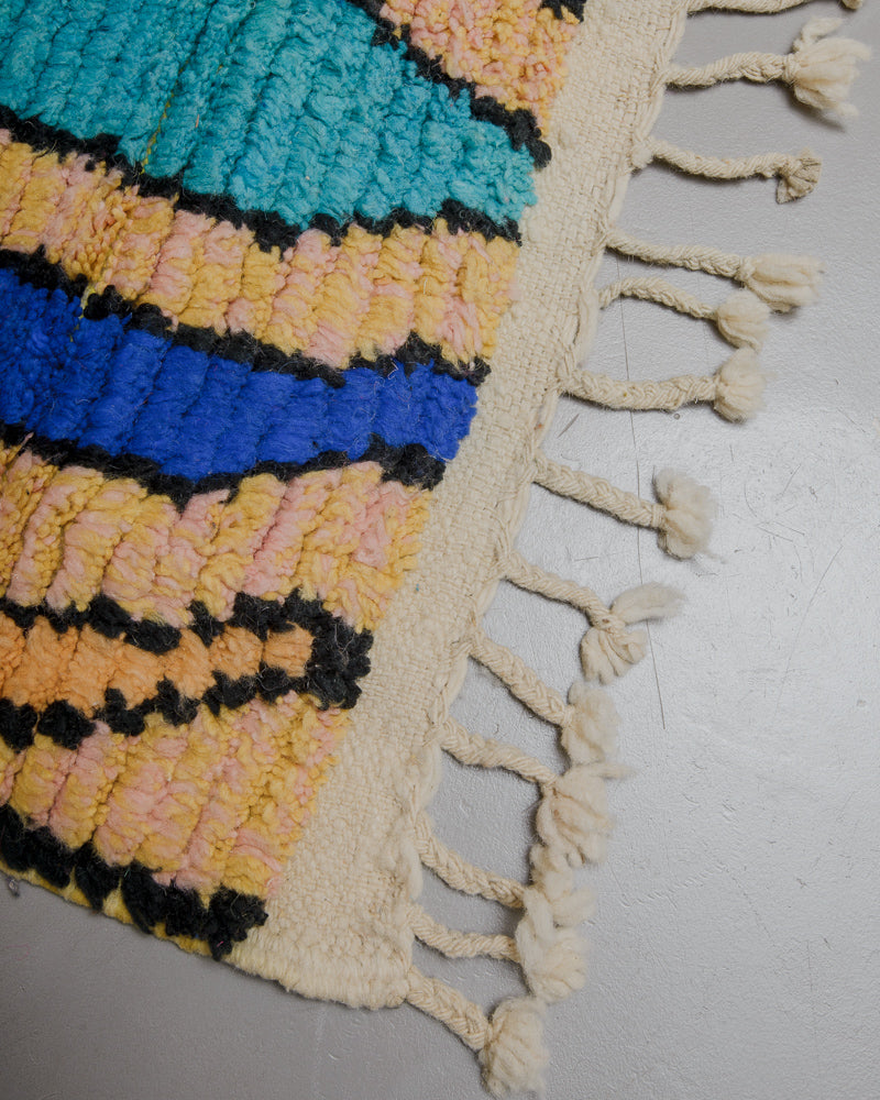 Corner of Boujaad runner rug with natural wool tassels. 