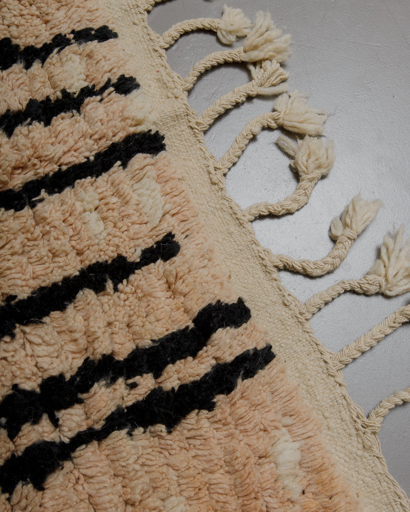 Edge of vintage rug with natural wool tassels. 