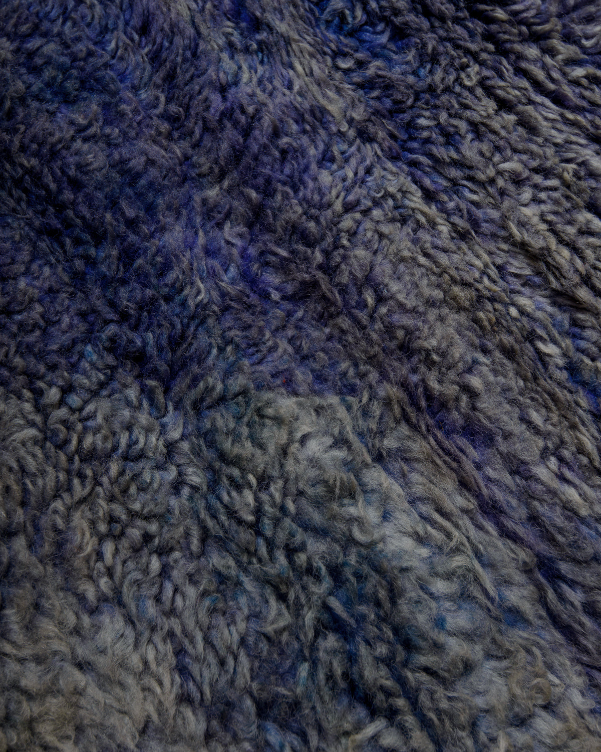 Close up of vintage boujaad rug showing the different shades of blue and purple and surface texture.