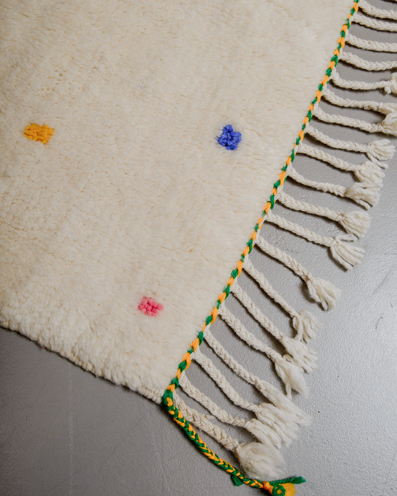 Edge of Berberlin finest rug with green and yellow trim and natural wool tassels. 