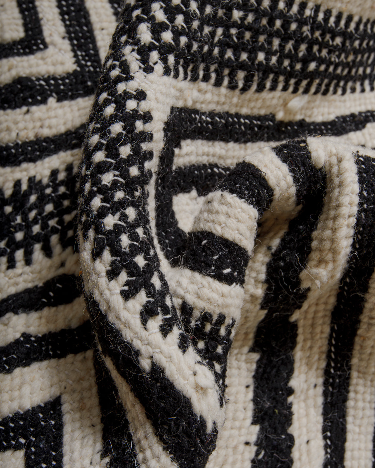 Close-up of a black and white patterned wool Kelim rug.