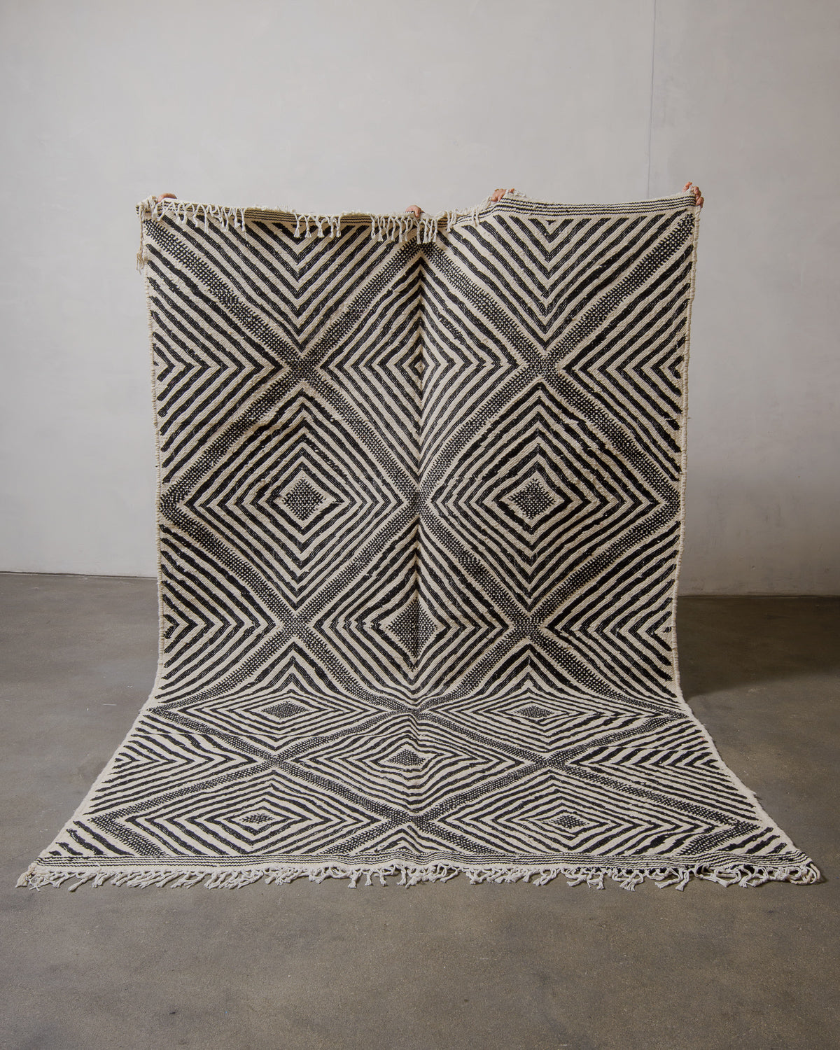 Geometric patterned Kelim rug with black and white design on a plain background