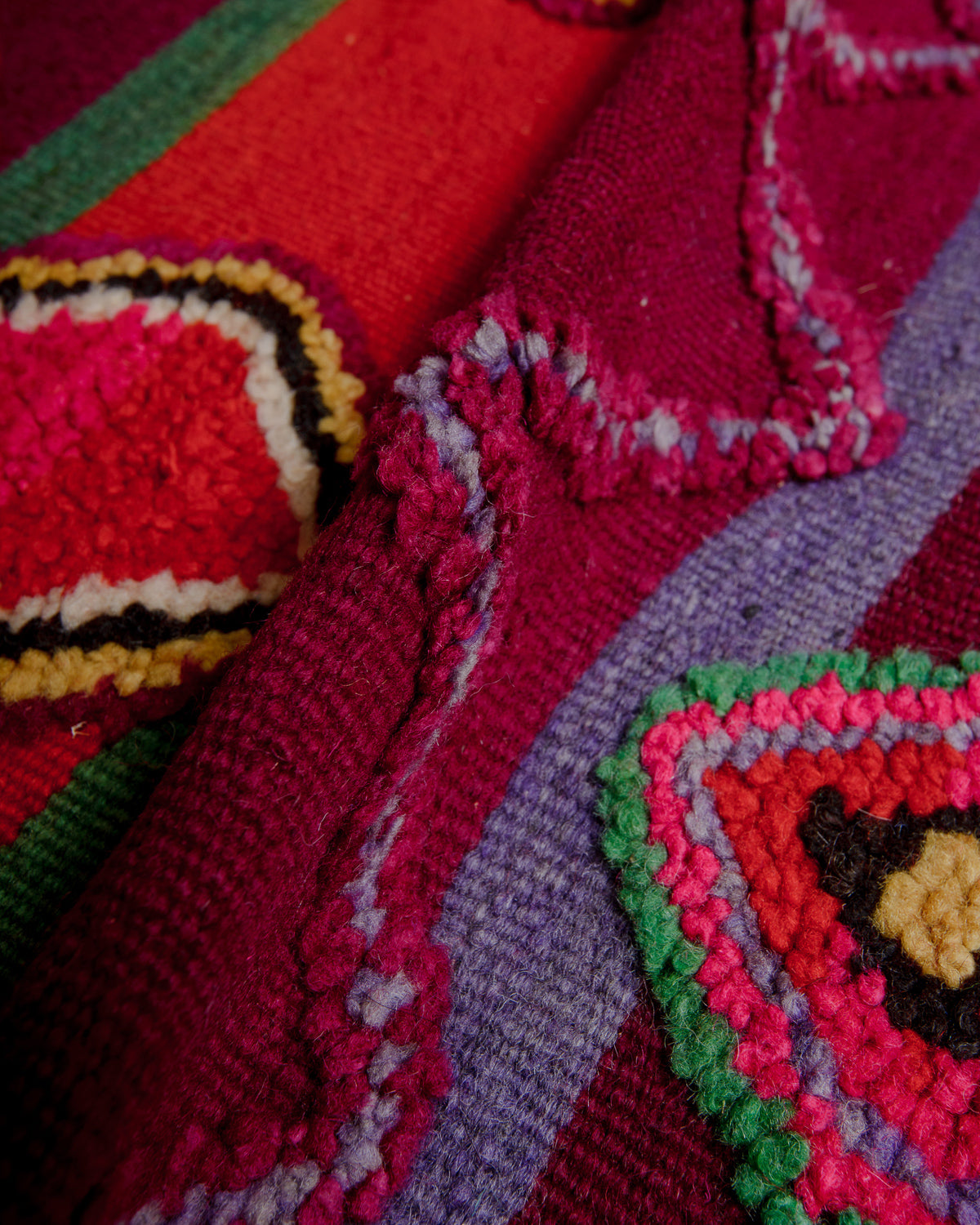 Close up showing the embroidered, raised details on the surface of the rug.