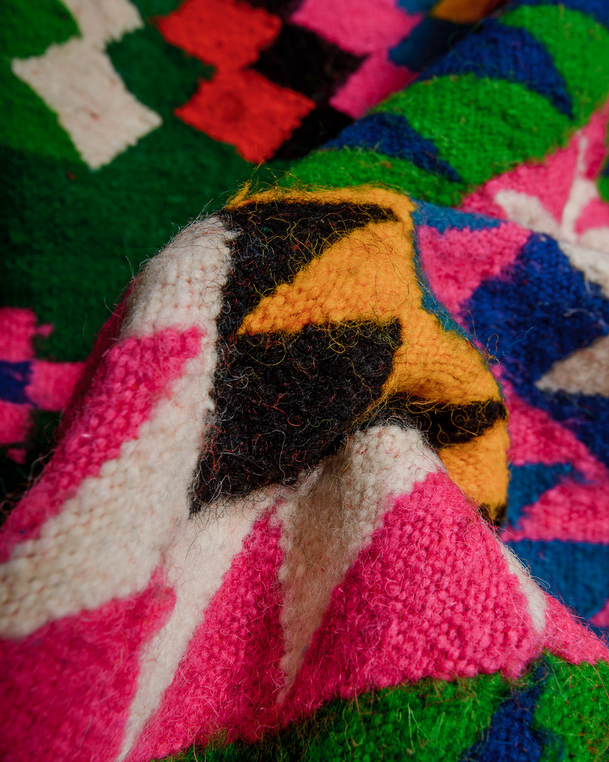 Close-up of a colorful woven wool fabric with geometric patterns
