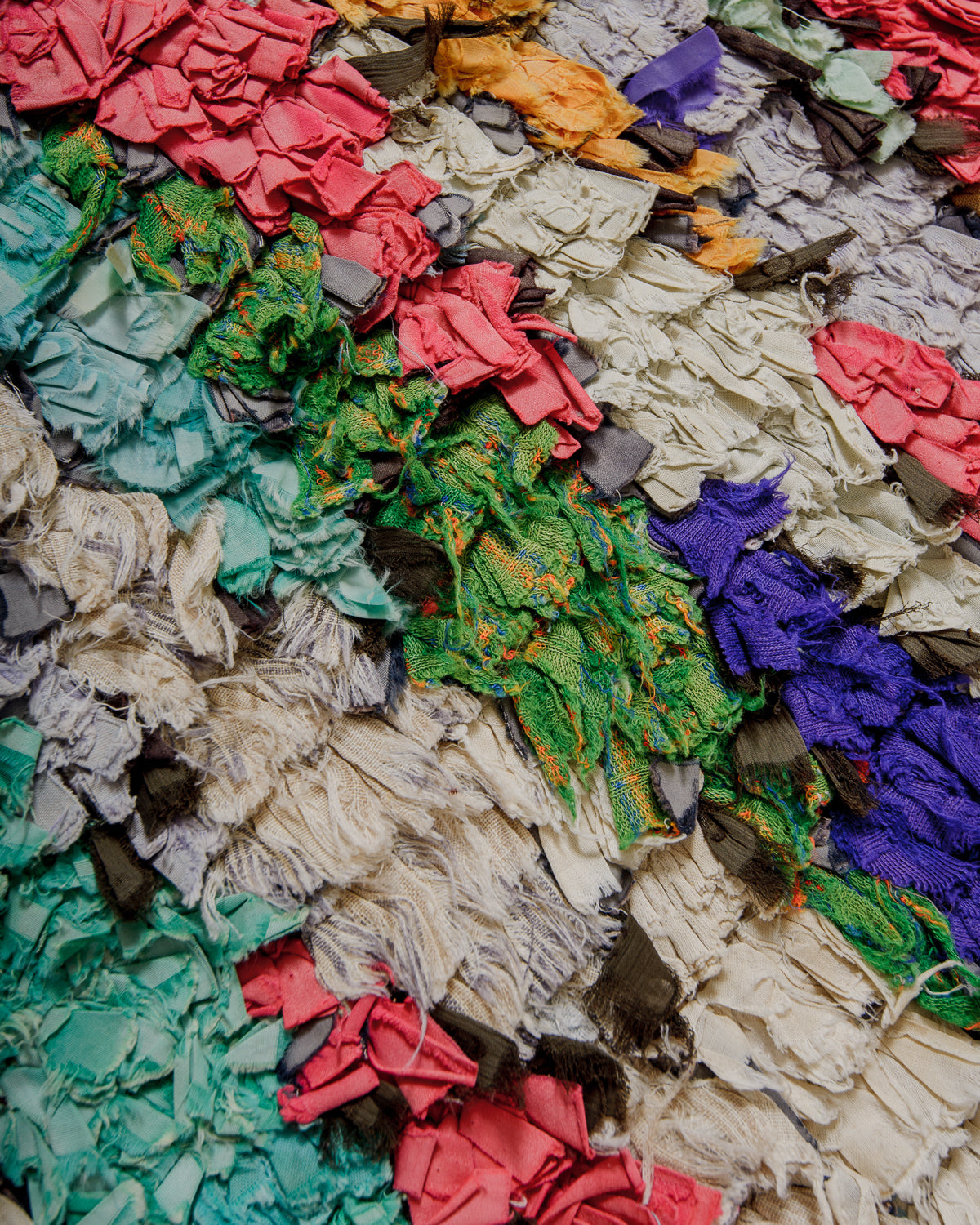 Surface of multicoloured textured fabric rug