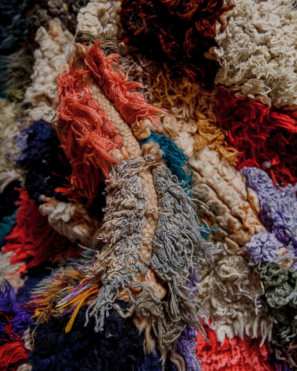 Close-up of a textured, multicolored fabric rug.