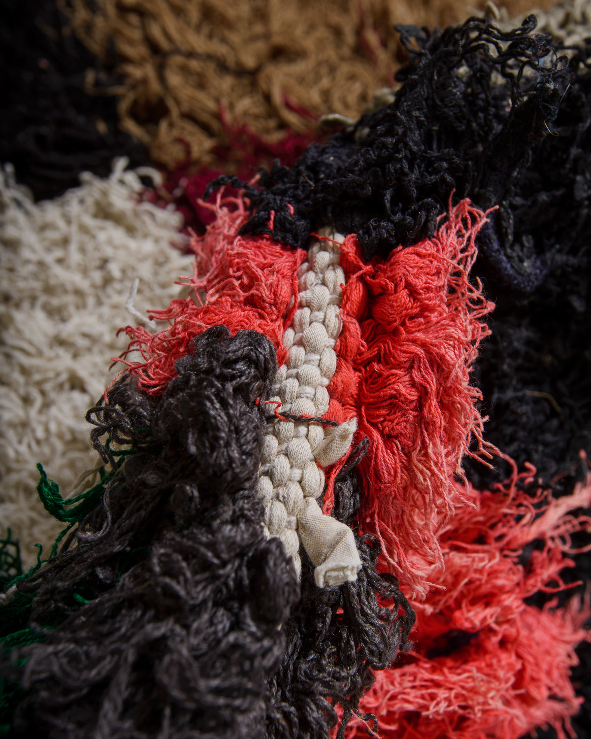 Close-up of textured fabric with red, black, and white colors.