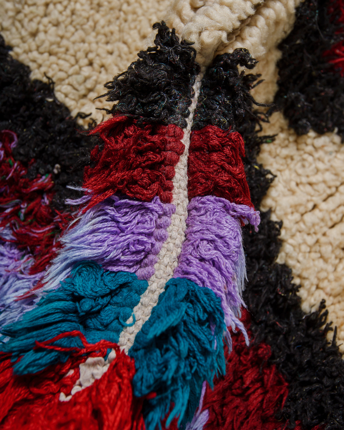 Close-up of a textured fabric with colorful yarn patterns