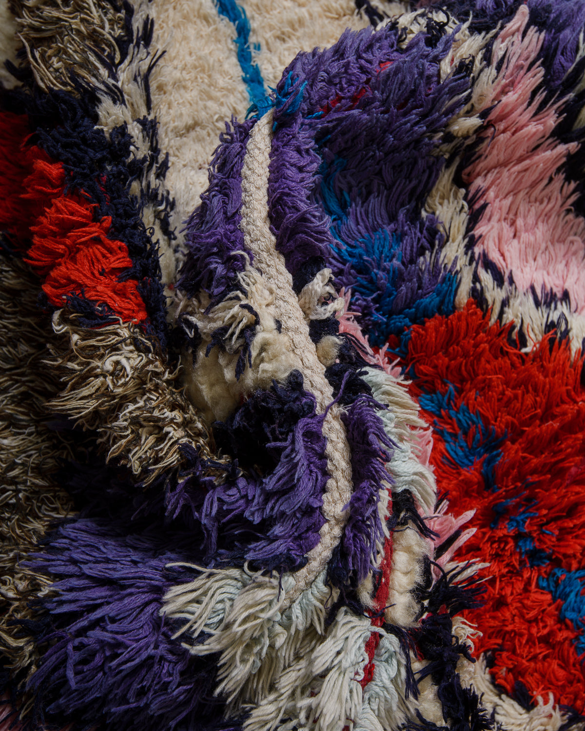 Close-up of textured fabric with multicolor shaggy pattern