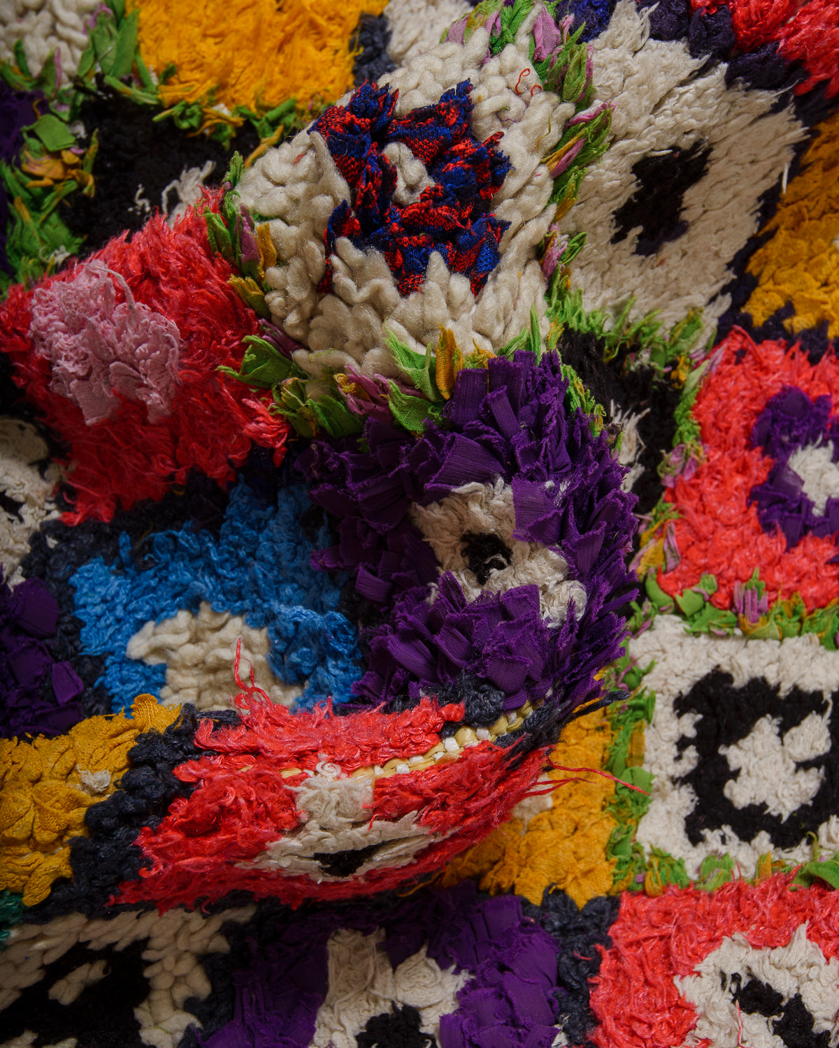 Close-up of a colourful woven textile with geometric patterns