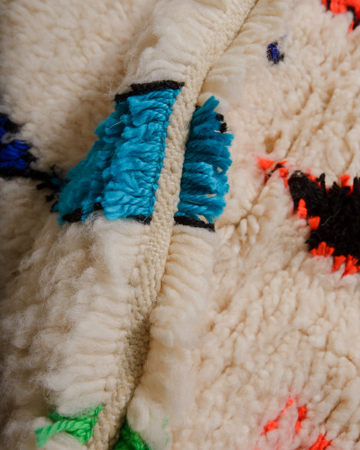 Detail of Azilal rug showing the spacing of the knotted rows and fluffy texture of the wool and soft cotton.