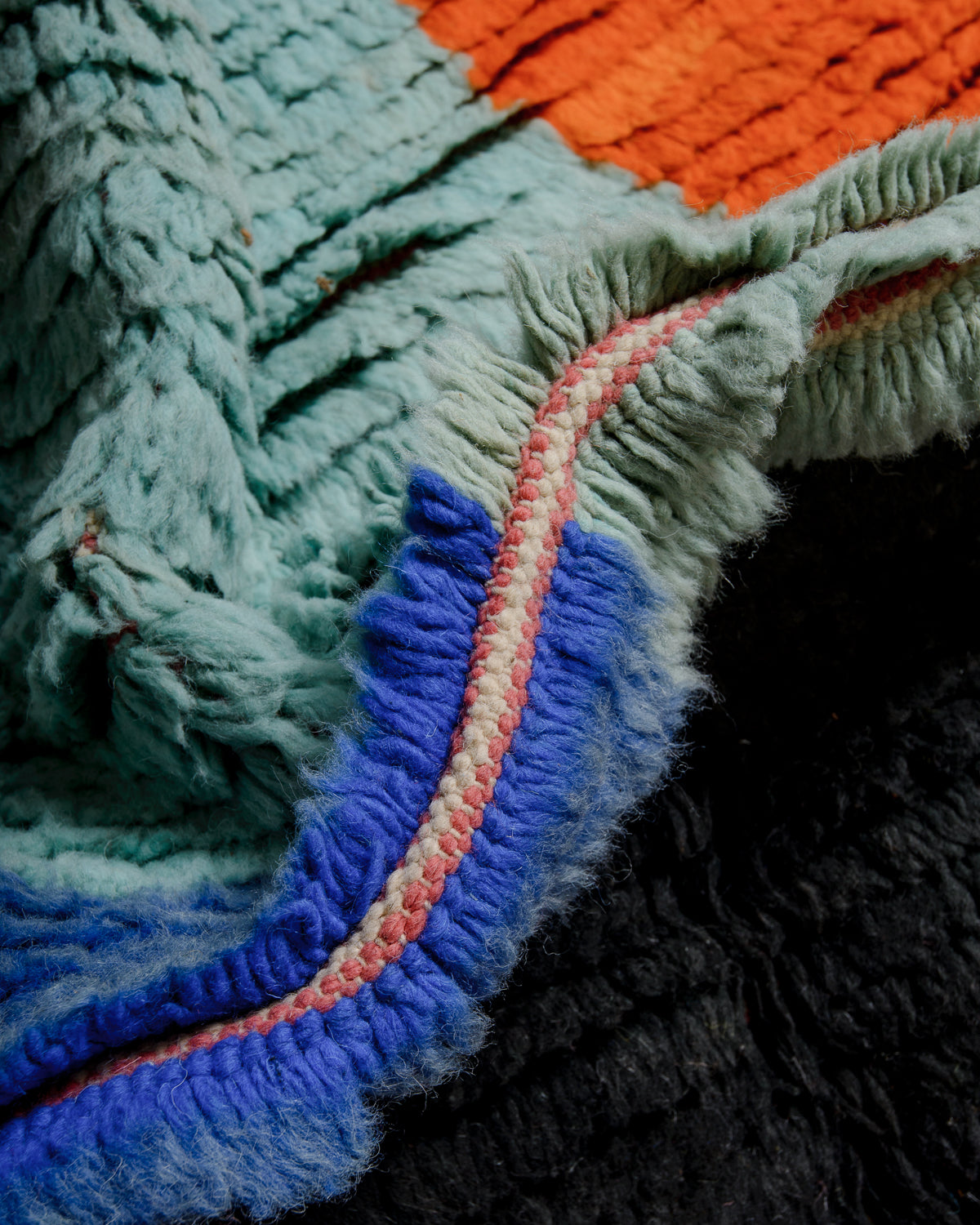 Detail of vintage berber rug showing the density of knots and thickness of wool.