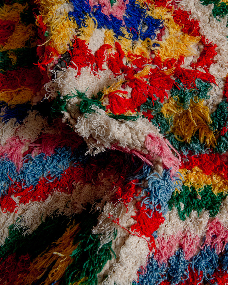 Close up of boucherouite rug with colourful cotton and fabric remnants.
