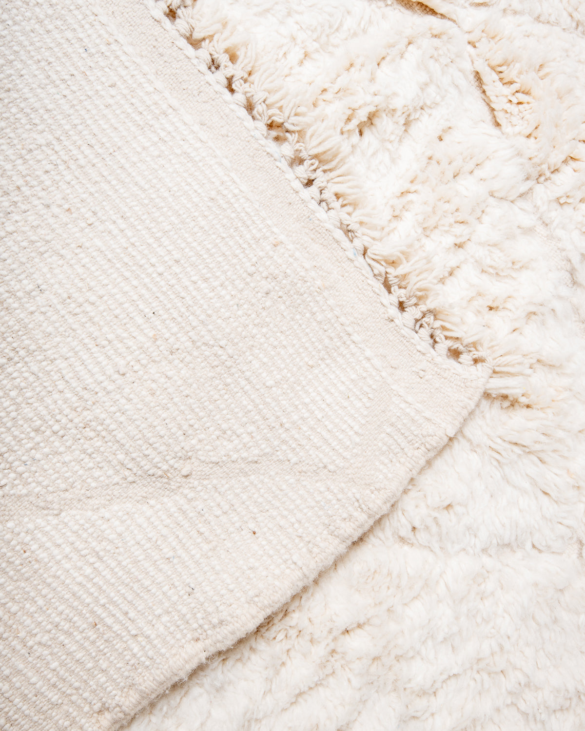 Modern, designer, handcrafted Berber rug from Morocco. Beniourain carpet with minimalist design, natural wool pile and a fluffy texture.