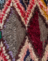 Modern designer vintage handcrafted Berber rug from Morocco. Boucherouite runner rug with beautiful colors and patterns.